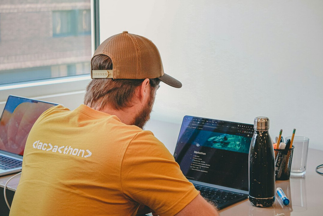 person coding on laptop at desk