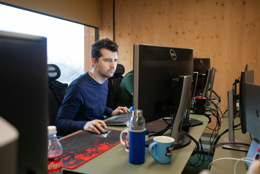 successful programmer at desk