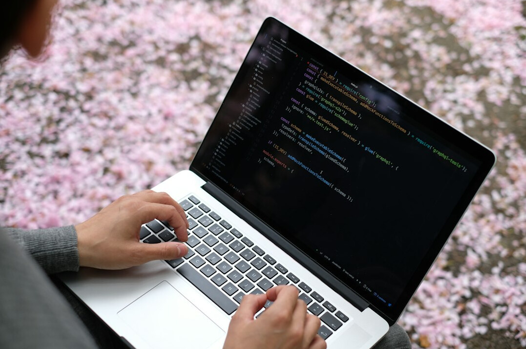 young programmer coding on laptop