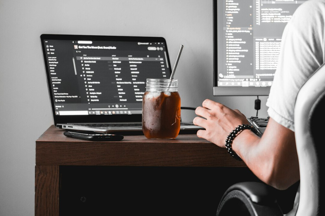 young programmer coding on laptop