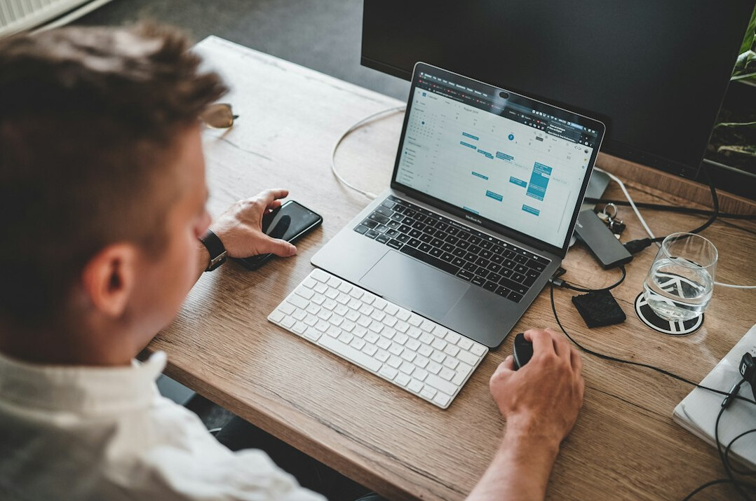 person coding on laptop at desk