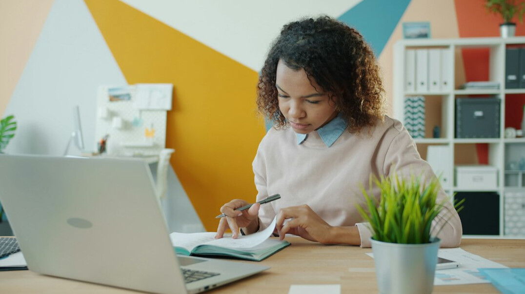 woman studying at desk with notebook