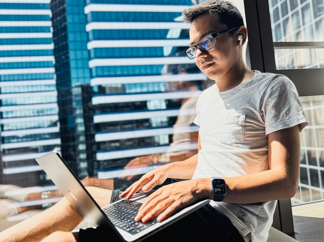 young man coding on laptop